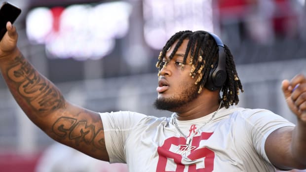 Nov 4, 2023; Tuscaloosa, Alabama, USA; Alabama Crimson Tide offensive lineman JC Latham (65) stretches on the field before a game against the LSU Tigers at Bryant-Denny Stadium. Mandatory Credit: Gary Cosby Jr.-USA TODAY Sports